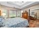 Main bedroom with natural light, hardwood floors, and tray ceiling at 1526 Oakleaf Dr, Auburn, GA 30011