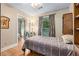 Bedroom featuring a sliding-door closet, wood floors, and nature views at 1526 Oakleaf Dr, Auburn, GA 30011