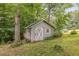 A charming cabin surrounded by trees with a wooden door and white trim at 1526 Oakleaf Dr, Auburn, GA 30011
