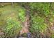A small creek with lush vegetation at 1526 Oakleaf Dr, Auburn, GA 30011