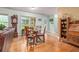 Cozy dining area features hardwood floors, glass table and backyard view at 1526 Oakleaf Dr, Auburn, GA 30011