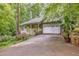Home with a charming front porch, a two-car garage, and landscaped yard at 1526 Oakleaf Dr, Auburn, GA 30011