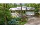 Charming home featuring a welcoming front porch, a two-car garage, and colorful landscaping at 1526 Oakleaf Dr, Auburn, GA 30011