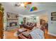 Inviting living room with a stone fireplace, hardwood floors, and comfortable furniture at 1526 Oakleaf Dr, Auburn, GA 30011