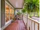 Charming porch with wooden flooring, adorned with hanging plants and chairs at 1526 Oakleaf Dr, Auburn, GA 30011