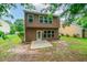 This backyard features a small patio and an expansive lawn at 162 Ledgewood Mill Way, Lawrenceville, GA 30045
