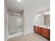 Full bathroom with a glass door shower, double sink vanity, and tile flooring at 162 Ledgewood Mill Way, Lawrenceville, GA 30045