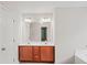 Bathroom vanity featuring double sinks and a large mirror with decorative lighting at 162 Ledgewood Mill Way, Lawrenceville, GA 30045