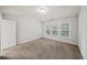 This spacious bedroom features three large windows and neutral carpeting at 162 Ledgewood Mill Way, Lawrenceville, GA 30045