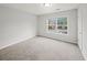 Bedroom featuring a window, carpet flooring, and a neutral color scheme at 162 Ledgewood Mill Way, Lawrenceville, GA 30045