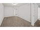 Neutral bedroom with plush carpet, a closet, and a large window overlooking a residential street at 162 Ledgewood Mill Way, Lawrenceville, GA 30045