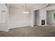 Elegant dining room with classic wainscoting, a modern chandelier, and fireplace, perfect for entertaining guests at 162 Ledgewood Mill Way, Lawrenceville, GA 30045