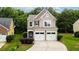 Charming two-story home with a well-maintained lawn, complemented by a two car garage and inviting curb appeal at 162 Ledgewood Mill Way, Lawrenceville, GA 30045