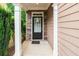 Inviting front entrance with stone accents, a stylish black door, and well-manicured greenery on a covered porch at 162 Ledgewood Mill Way, Lawrenceville, GA 30045