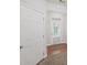 Hallway featuring a closet with wooden floors and a white door leading to the exterior with a window above at 162 Ledgewood Mill Way, Lawrenceville, GA 30045