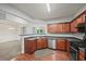Efficient kitchen featuring stainless appliances, wood floors, stylish cabinetry, and seamless flow into other living spaces at 162 Ledgewood Mill Way, Lawrenceville, GA 30045