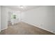Loft space featuring plush carpet, neutral paint, a window and a view of the hallway at 162 Ledgewood Mill Way, Lawrenceville, GA 30045