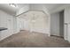Bright open-plan living room featuring neutral walls, plush carpet and an open entrance to the dining area at 162 Ledgewood Mill Way, Lawrenceville, GA 30045