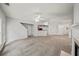 Open-concept living room with access to the kitchen, dining area, a fireplace and a backyard view at 162 Ledgewood Mill Way, Lawrenceville, GA 30045