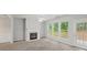 Cozy living room featuring neutral paint, a fireplace and large windows offering backyard views at 162 Ledgewood Mill Way, Lawrenceville, GA 30045