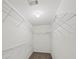Walk-in closet with wall to wall shelving and neutral carpeting at 162 Ledgewood Mill Way, Lawrenceville, GA 30045
