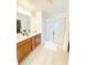Bathroom view featuring double vanity, wood cabinets, and glass enclosed shower stall at 3130 Haynes Park Dr, Lithonia, GA 30038