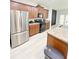 Modern kitchen with stainless steel appliances, brown cabinetry, and light wood-style flooring at 3130 Haynes Park Dr, Lithonia, GA 30038