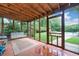 Enclosed back porch leading to a stunning pool and garden view with outdoor seating at 2578 Morgan Lake Ne Dr, Marietta, GA 30066