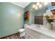 Bright bathroom featuring a white vanity with a sink, with a framed mirror and traditional light fixture at 2578 Morgan Lake Ne Dr, Marietta, GA 30066