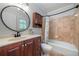 Bathroom featuring a dark wood vanity, an oval framed mirror, a toilet and a tub with tile surround at 2578 Morgan Lake Ne Dr, Marietta, GA 30066