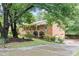 Traditional brick home featuring an attached garage, well-kept lawn, and mature shade trees at 2578 Morgan Lake Ne Dr, Marietta, GA 30066