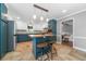 Stylish eat-in kitchen with stainless appliances, tile backsplash, and a central island with barstool seating and modern pendant lights at 2578 Morgan Lake Ne Dr, Marietta, GA 30066