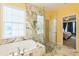 Luxurious bathroom featuring a marble-tiled shower and soaking tub at 266 Monarch Village Way, Stockbridge, GA 30281