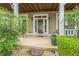 Close up of the welcoming front porch with detailed trim and manicured landscaping at 266 Monarch Village Way, Stockbridge, GA 30281