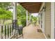 Inviting front porch featuring a seating area with views of the landscaped front yard at 266 Monarch Village Way, Stockbridge, GA 30281