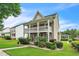 Charming two-story home with landscaped front yard and a cozy porch at 266 Monarch Village Way, Stockbridge, GA 30281