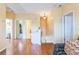 Open hallway with hardwood floors, access to various rooms, and bright, neutral walls at 266 Monarch Village Way, Stockbridge, GA 30281