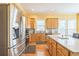 Well-lit kitchen with stainless steel refrigerator, granite counters, and ample cabinet space at 266 Monarch Village Way, Stockbridge, GA 30281