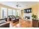 Bright living room with hardwood floors, a fireplace, and custom built-in shelving at 266 Monarch Village Way, Stockbridge, GA 30281