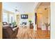 Bright living room with hardwood floors, a fireplace, and custom built-in shelving at 266 Monarch Village Way, Stockbridge, GA 30281