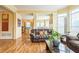 Spacious living room with hardwood floors, large windows, and an open layout to the kitchen at 266 Monarch Village Way, Stockbridge, GA 30281