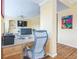 Home office with built-in desk, shelving, and view of living area at 266 Monarch Village Way, Stockbridge, GA 30281