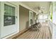 Comfortable front porch with seating and a ceiling fan for warm days at 266 Monarch Village Way, Stockbridge, GA 30281