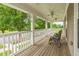 Relaxing front porch with wood floors, ceiling fans, and white railing at 266 Monarch Village Way, Stockbridge, GA 30281