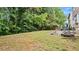 View of backyard with patio, lawn, and bordered by a treeline that provides shade and privacy at 3614 Clearbrooke Way, Duluth, GA 30097