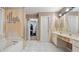 Bright bathroom with a large tub, tiled floors, and a double vanity at 3614 Clearbrooke Way, Duluth, GA 30097