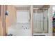 This bathroom features a tub, shower, and a bright window at 3614 Clearbrooke Way, Duluth, GA 30097