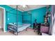 This bedroom features blue walls, a four poster bed, and workspace at 3614 Clearbrooke Way, Duluth, GA 30097