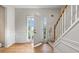 Entryway with hardwood floors, decorative trim, and a staircase with wooden banister at 3614 Clearbrooke Way, Duluth, GA 30097