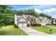 Charming two-story home featuring a well-manicured lawn, brick accents, and a two-car garage at 3614 Clearbrooke Way, Duluth, GA 30097